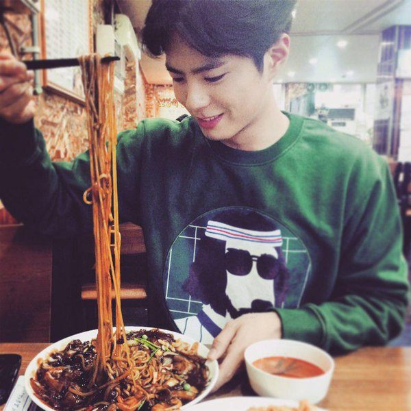 Park Bo Gum eating black bean noodles for the movie, Chinatown. / Chinatown Official Twitter